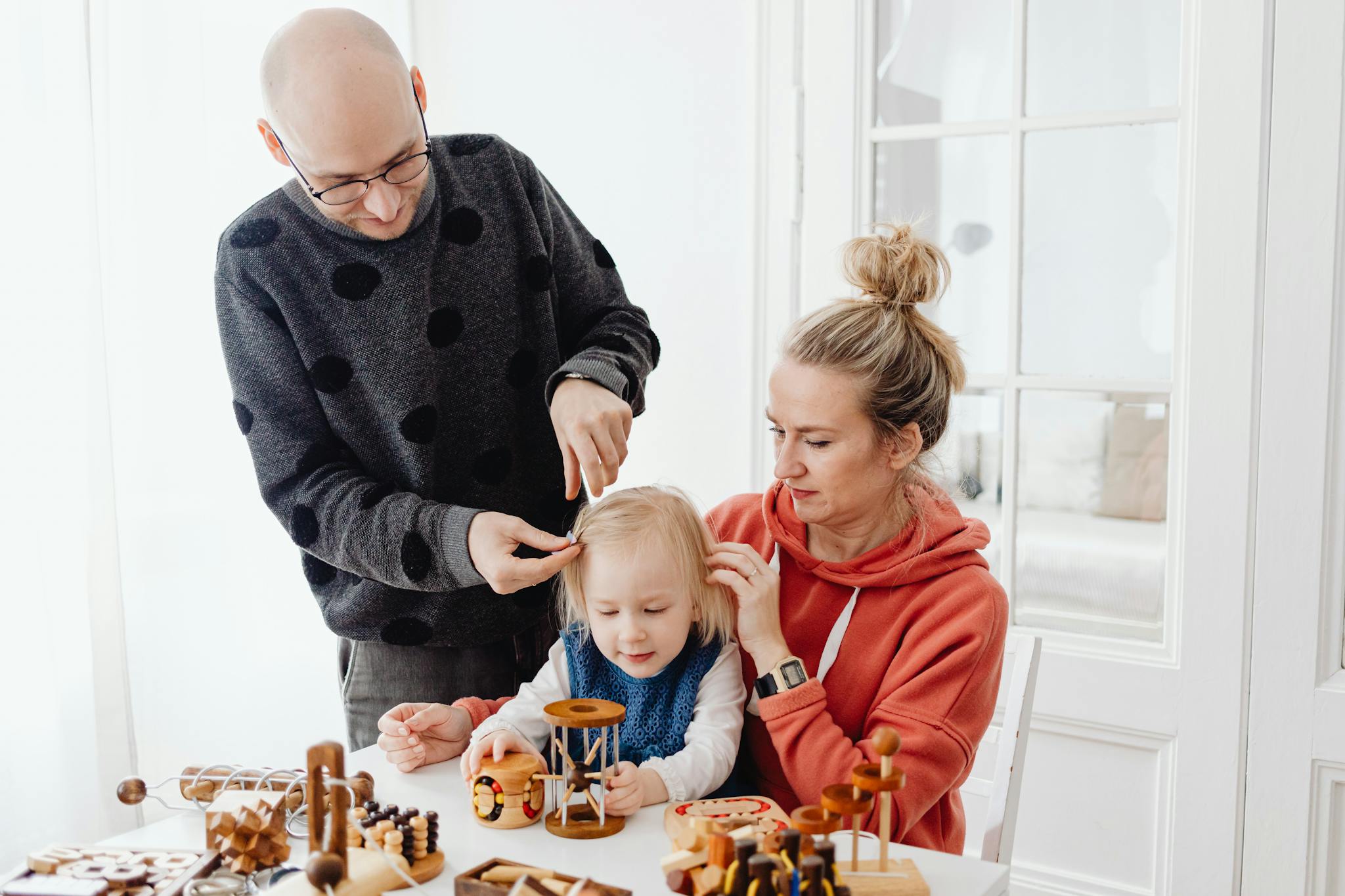Family spending quality time together, playing with toys indoors.